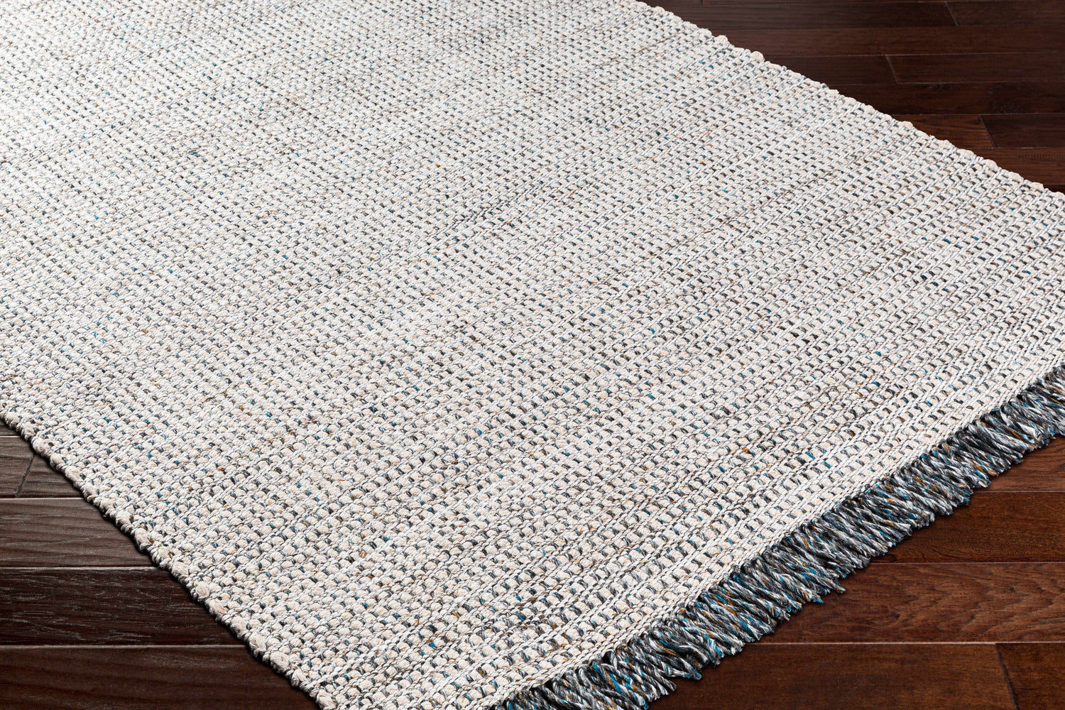 Close-up of the Beige Teal Aron Area Rug showing its woven texture and teal, brown, and charcoal flecks. Corner
