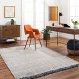 Home office with Beige Teal Aron Area Rug, wood desk, orange chair, and modern decor. Roomscene-Rectangle