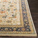 Close-up of the hand-knotted Starford Carpet. Traditional floral pattern in ivory, blue, and orange on a wool rug. Front