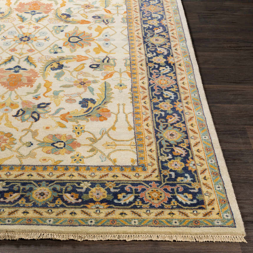 Close-up of the hand-knotted Starford Carpet. Traditional floral pattern in ivory, blue, and orange on a wool rug. Front