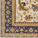 Close-up of the Starford Carpet: hand-knotted NZ wool rug with a traditional floral pattern in navy, gold, and ivory. Swatch