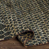 Close-up of the Stephentown Clearance Jute Rug showing its hand-knotted texture and contemporary black, tan, and cream pattern. Fold