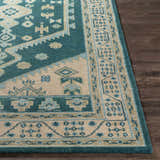 Close up of the hand-knotted Stepps Area Rug featuring aqua, beige, and sage tones with a traditional oriental pattern. Front