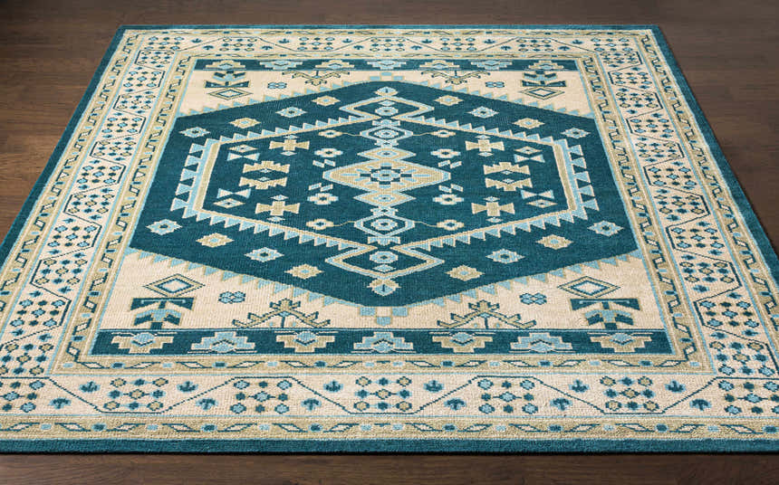 Close-up of the Stepps Area Rug. Hand-knotted wool rug with aqua, beige, sage, and teal bohemian-inspired geometric design. Front