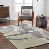 Contemporary living room scene with a beige and gray Duru Area Rug, wood floors, gray chair, and modern wood cabinet. Roomscene-Rectangle