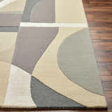 Close-up of the Duru Area Rug showing its beige, gray, and cream geometric pattern and hand-tufted wool texture. Front