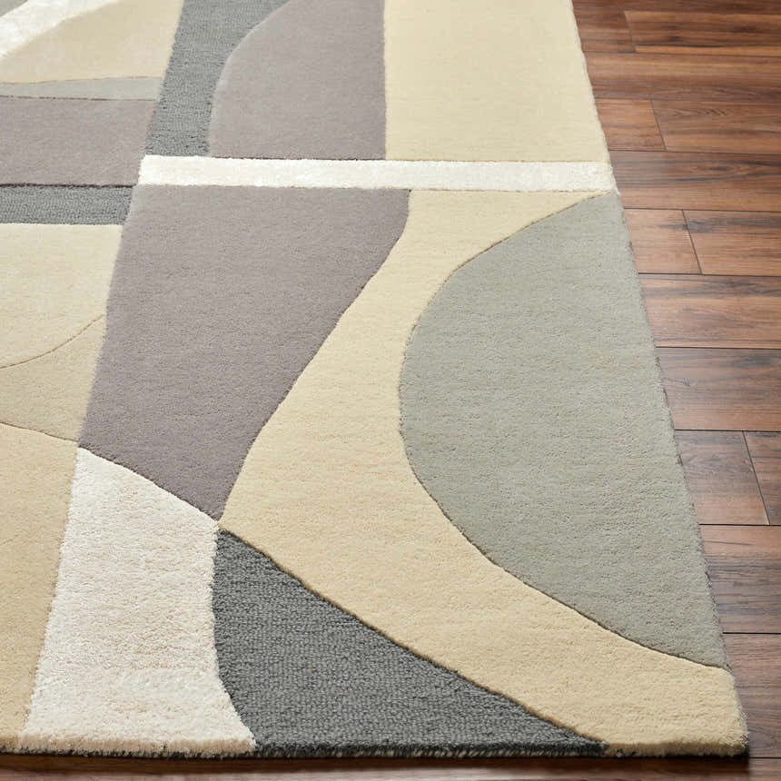 Close-up of the Duru Area Rug showing its beige, gray, and cream geometric pattern and hand-tufted wool texture. Front