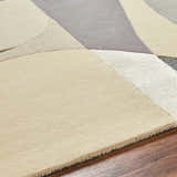 Close up of the hand tufted Duru Area Rug, featuring a contemporary beige, cream, and gray geometric design. Texture