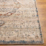 Close-up of the Stratmoor Area Rug. Beige, blue, and burnt orange traditional pattern on a polyester rug with a subtle texture. Front