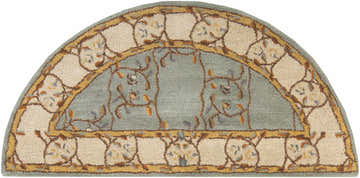 Close-up of a hearth-shaped Stringer Area Rug. Features a beige floral border and sage center with leaf accents. Design-Hearth