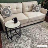 Living room scene with a Kingscourt Washable Area Rug in gray, beige sofa, and marble side table. Contemporary style. Roomscene-Rectangle