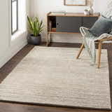 Modern entryway with a cream and gray Sula Area Rug, wood floors, cabinet, chair, and plant. Roomscene-Rectangle