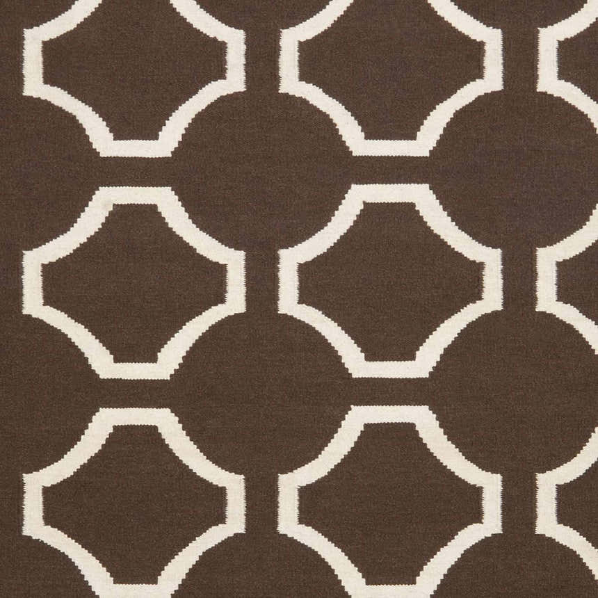 Close-up of the Sulligent Area Carpet. Dark brown wool rug with a geometric light beige pattern. Hand woven texture. Swatch