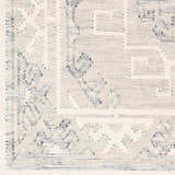 Close up of the hand woven Anund Area Rug showing beige and gray geometric patterns. Swatch