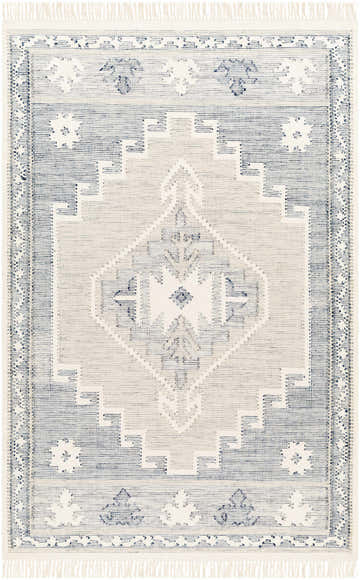 Close-up of the hand woven Dumi Area Rug, featuring a geometric pattern in blue and cream with fringe. Design-Rectangle-576
