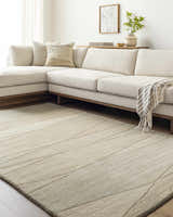 Living room scene with a tan Susie Modern Wool Rug, sectional sofa, and neutral decor. Roomscene-Rectangle