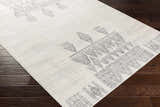 Close-up of Wakita Light Gray Tribal Rug, showing the geometric tribal pattern and soft light gray and charcoal colors. Corner