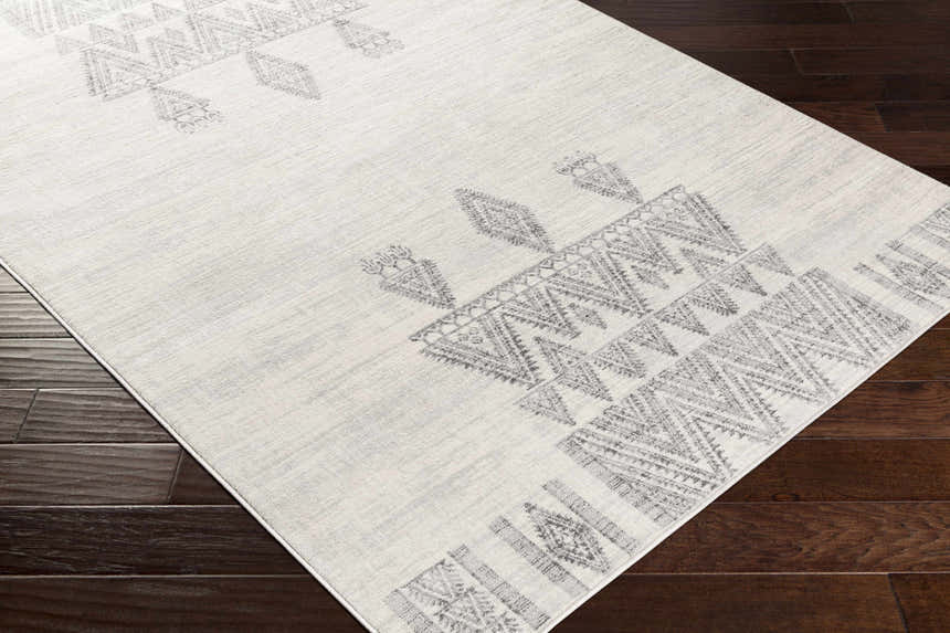 Close-up of Wakita Light Gray Tribal Rug, showing the geometric tribal pattern and soft light gray and charcoal colors. Corner