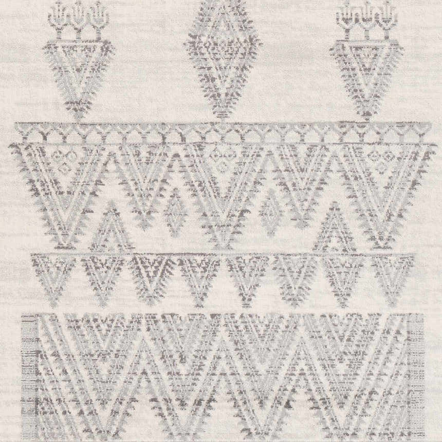 Close-up of Wakita Light Gray Tribal Rug. Bohemian style rug with charcoal and gray geometric pattern on off-white background. Swatch