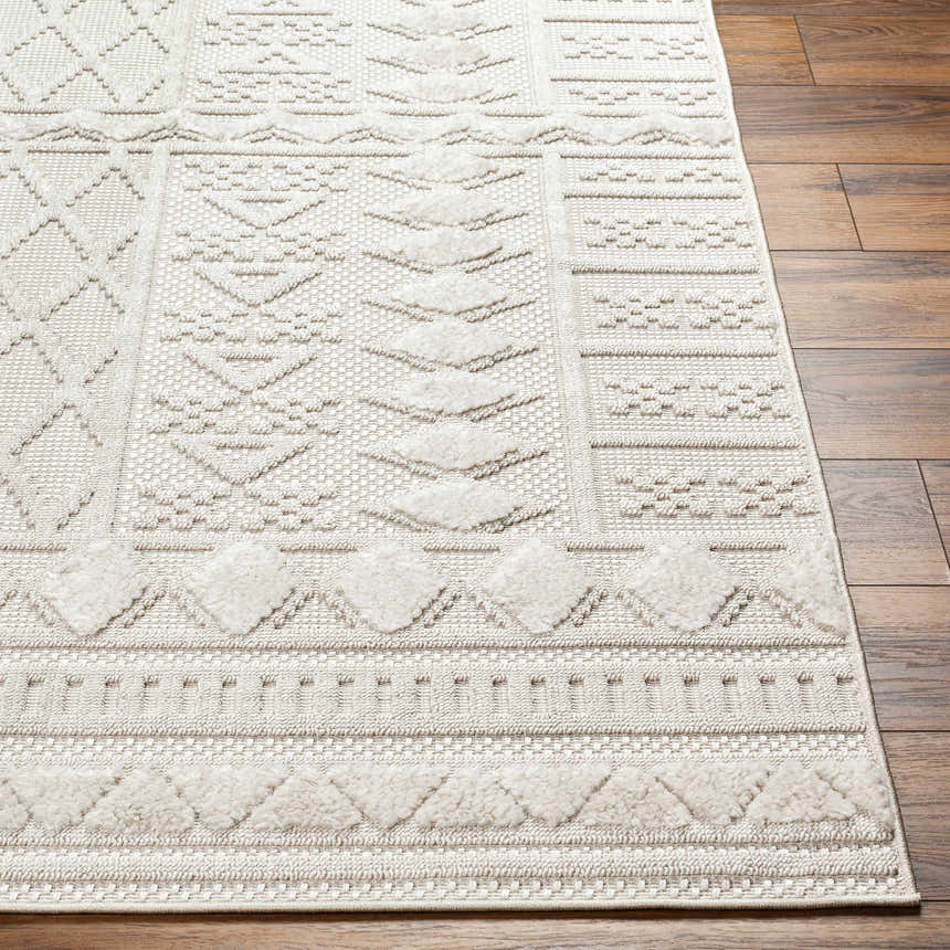 Close-up of the Elese Area Rug in beige and cream, showcasing its contemporary geometric pattern and textured details. Front