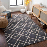 Living room scene with a gray and light gray Taclobo Area Rug featuring a geometric pattern. Mid-century modern decor. Roomscene-Rectangle