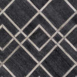 Close-up of the Taclobo Area Rug. Black rug with light gray geometric diamond pattern. Hand-crafted viscose rug. Swatch