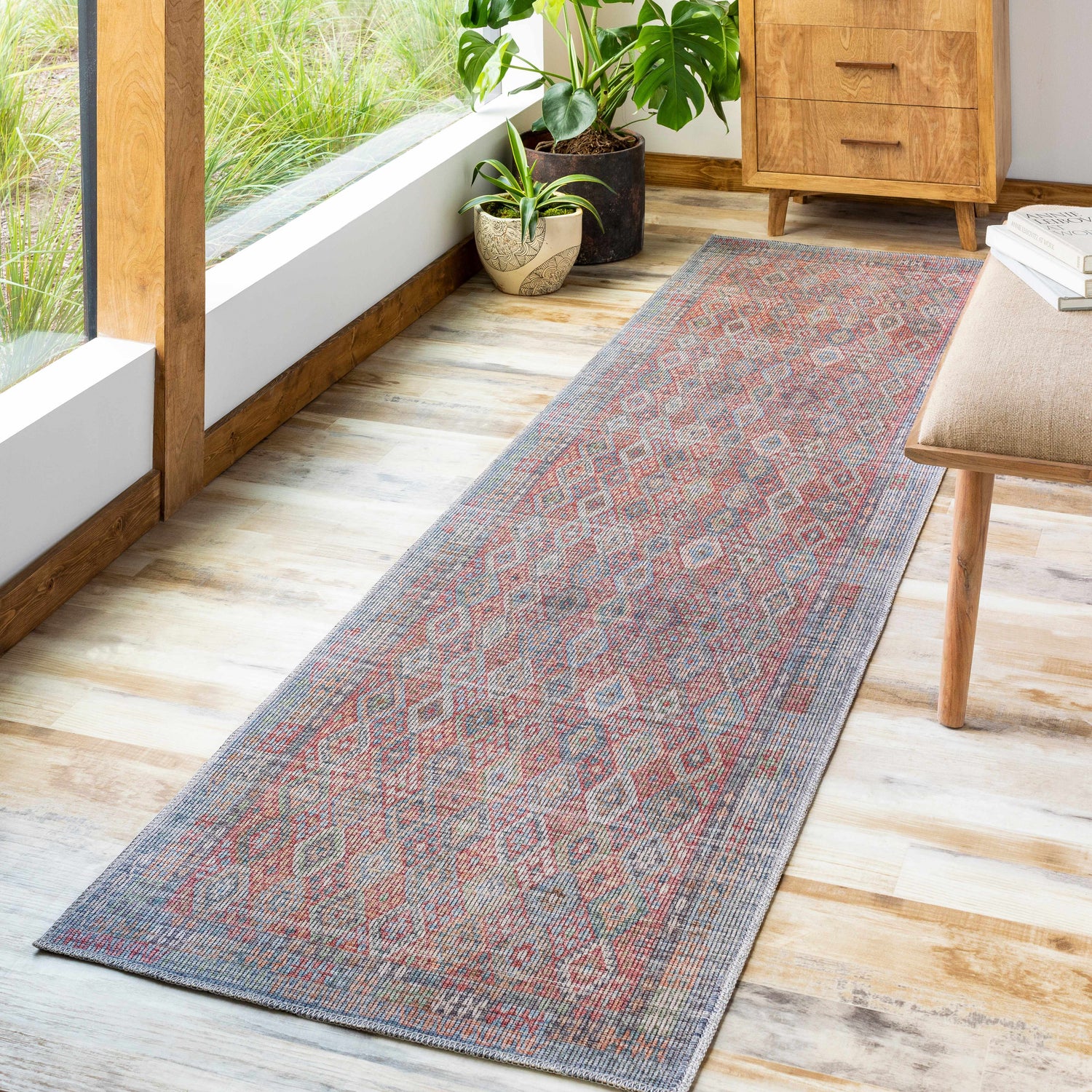 Sunlit hallway with Tajao Washable Printed Jute Rug. Runner rug in red, blue, and gray adds warmth to the light wood floors. Roomscene-Runner