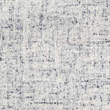 Close-up of the hand-tufted Tanana Area Rug. Cream wool rug with a contemporary black and gray abstract pattern. Swatch