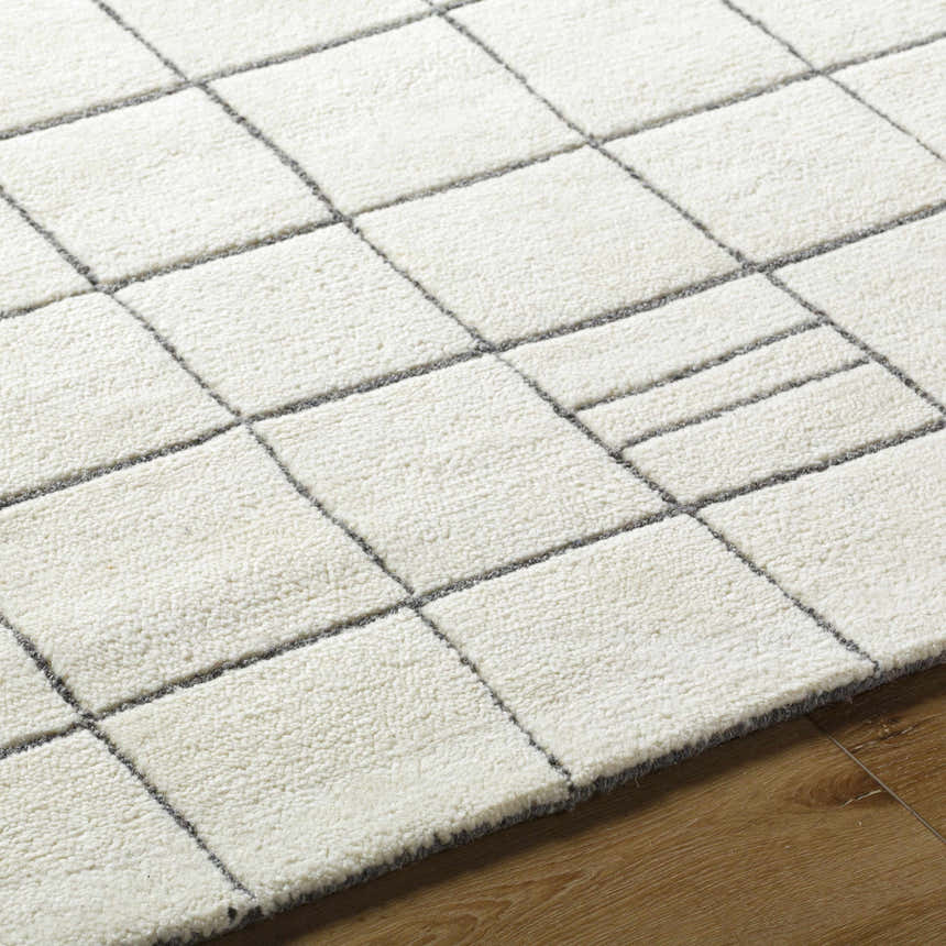 Close-up of the Tanya Pearl White Grid Wool Rug, showing off white wool and a gray grid pattern. Texture