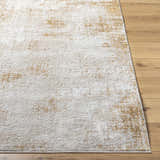 Close-up of the Tapko Tan Area Rug showing its distressed Southwestern design and soft polyester texture on wood floor. Front