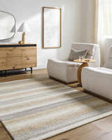 Living room scene with the striped Touca Area Rug, light wood floors, and neutral furniture. Roomscene-Rectangle