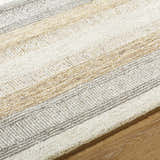 Close-up of the hand-tufted Touca Area Rug. Features ash, light silver, silver gray, and warm gray stripes. 100% wool texture. Texture