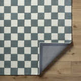 Close-up of the hand-tufted Timin Blue Gray Checkered Area Rug showing its cream and medium gray wool texture and backing. Fold