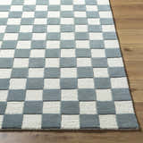 Close up of the Timin Blue Gray Checkered Area Rug showing cream and medium gray squares, and wool texture. Front