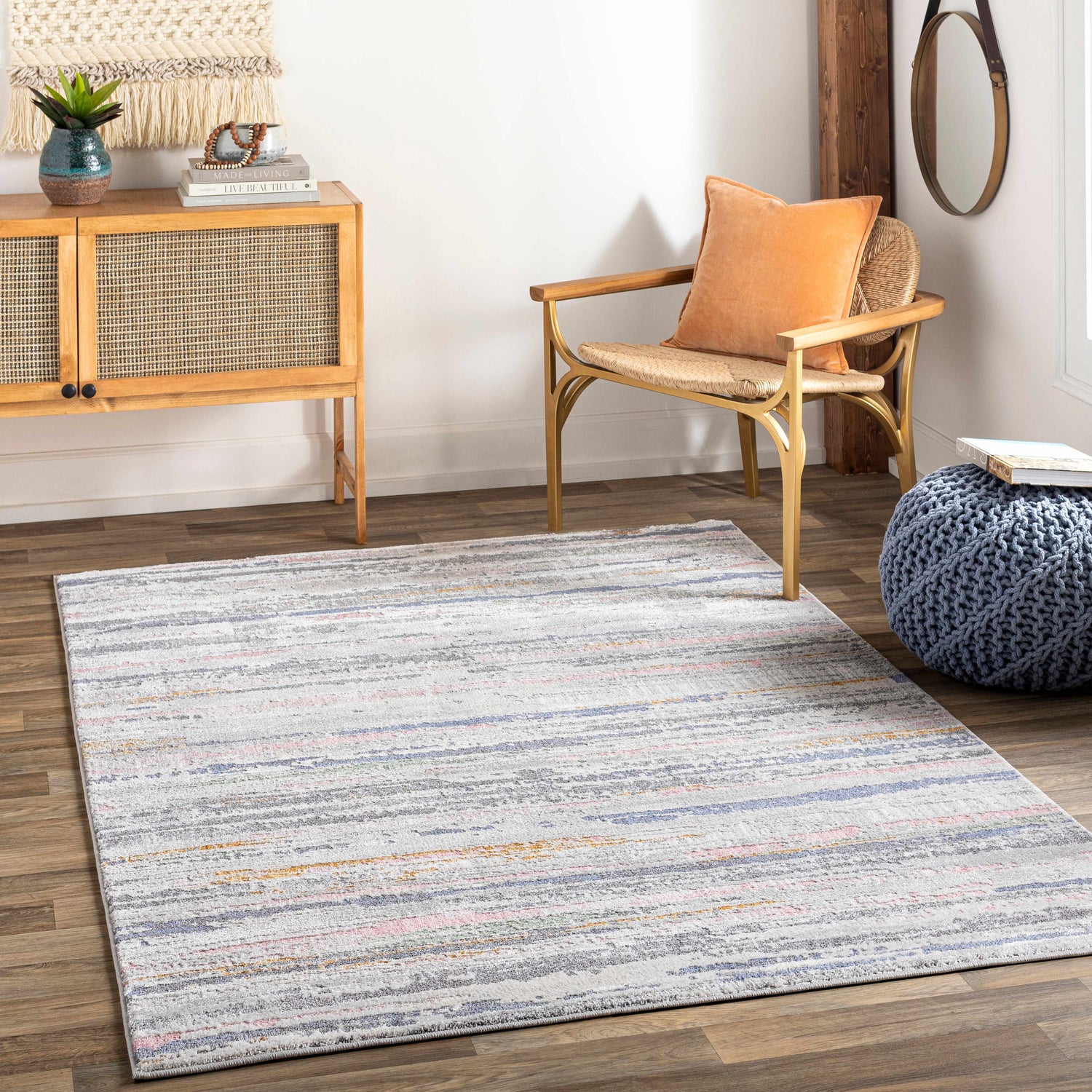 Living room scene with Tekirova Striped Area Carpet, wood floors, cabinet, chair, and blue pouf. Roomscene-Rectangle