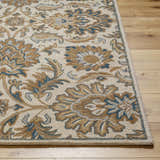 Close-up of the hand-tufted Teom Area Rug. Beige wool rug with a traditional floral pattern in camel, brown, and blue. Front