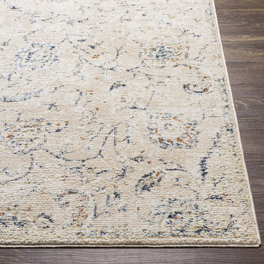 Close up of Ternate Area Rug showing cream, navy, and brick red details on a dark wood floor. Front