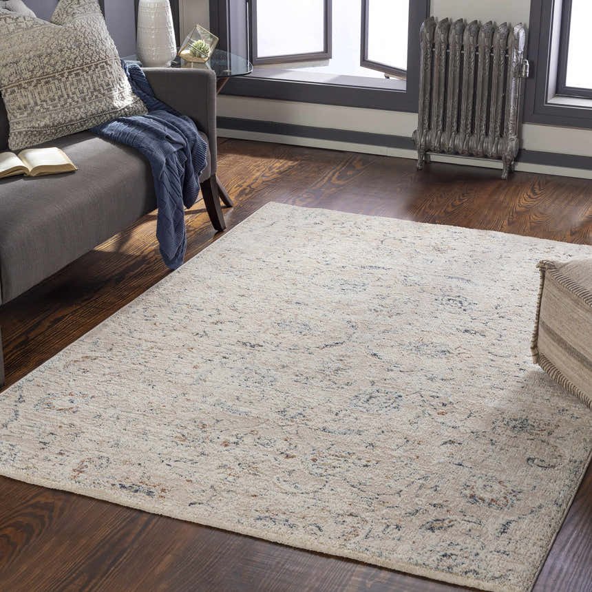 Living room scene with a cream Ternate Area Rug, gray sofa, and dark wood floors. Roomscene-Rectangle