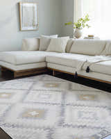 Living room scene with a cream sectional sofa and a Southwestern style Tyipa Area Rug in charcoal, cream, gray, and mustard. Roomscene-Rectangle