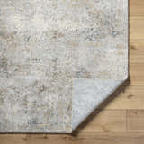 Close-up of the Twyla Thick Luxe Rug showing beige, gray, and tan tones with a contemporary abstract pattern. Fold