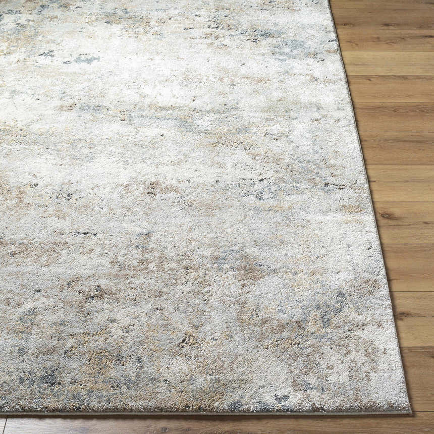 Close-up of the Twyla Thick Luxe Rug showing its beige, gray, and tan abstract design and plush texture on wood floors. Front