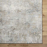 Close up of the Twyla Thick Luxe Rug showing beige, gray, and tan tones with a subtle contemporary pattern. Swatch