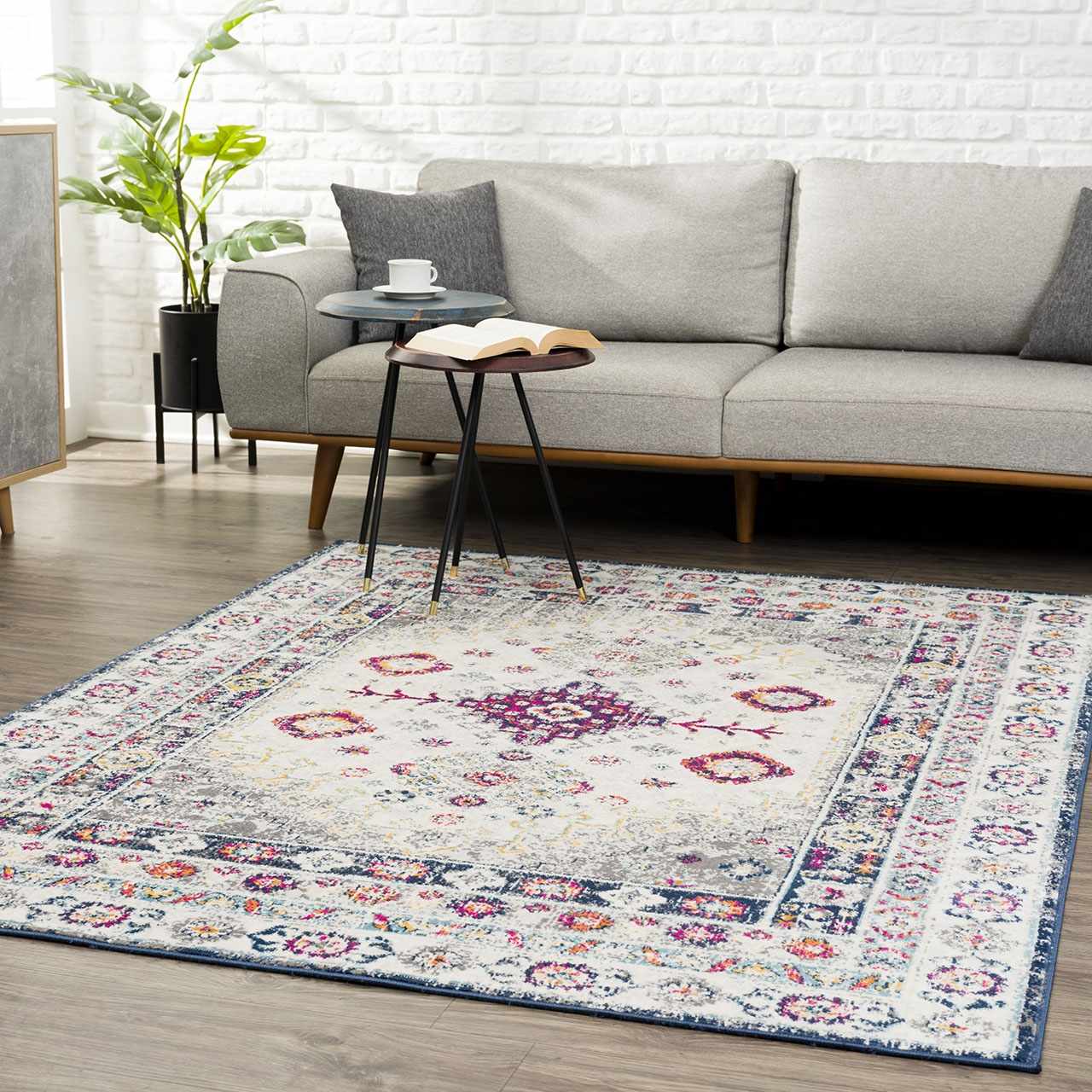 Living room scene with a Tigrim Beige 2306 Area Rug. The rug features a bohemian design with beige, ivory, and navy colors. Roomscene-Rectangle