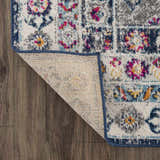 Close-up of Tigrim Beige 2306 Area Rug showing bohemian pattern, navy border, and polypropylene texture on wood floor. Fold