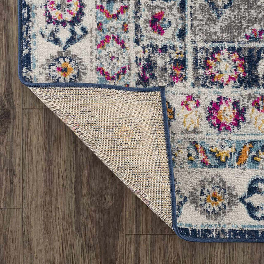 Close-up of Tigrim Beige 2306 Area Rug showing bohemian pattern, navy border, and polypropylene texture on wood floor. Fold