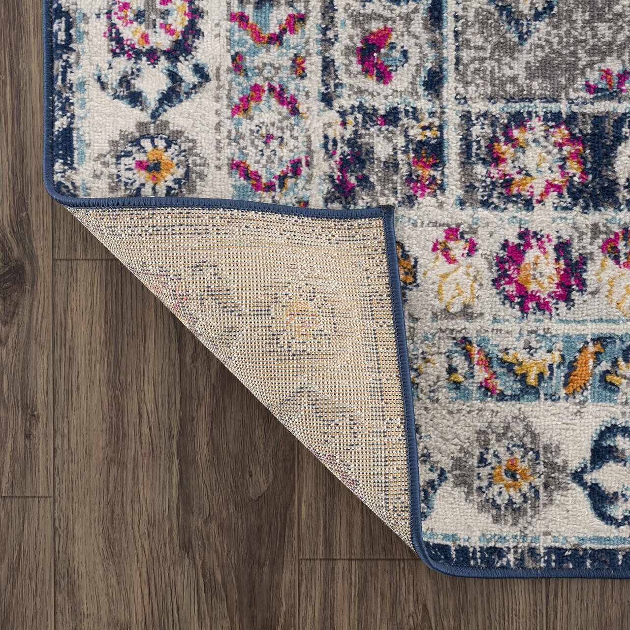 Close-up of Tigrim Beige 2306 Area Rug showing bohemian pattern, navy border, and polypropylene texture on wood floor. Fold