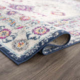 Close-up of Tigrim Beige 2306 Area Rug showing the bohemian floral pattern, ivory base, and navy border. Fold