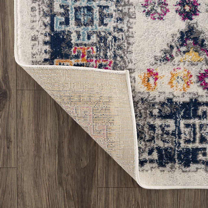 Close-up of Tigriv Ivory 2312 rug showing the ivory, gray, navy, and orange bohemian pattern and the rug's backing. Fold
