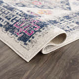 Close-up of the Tigriv Ivory 2312 area rug showing its ivory, navy, gray, and orange bohemian pattern and soft texture. Fold