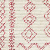 Close-up of the Tinawagan Area Rug: a cream rug with a textured, geometric diamond pattern in a soft red hue. Swatch